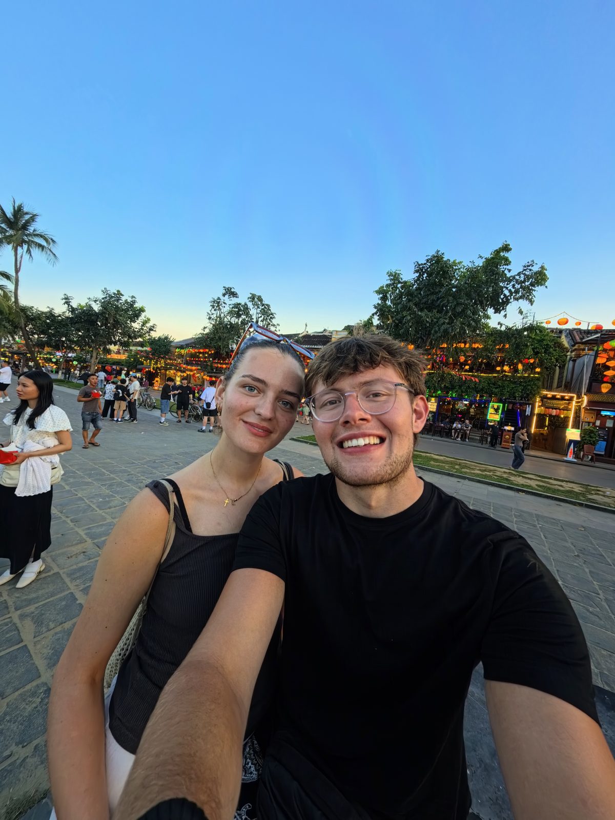 Charlie Bowman with a friend at sunset on a street in Hoi An